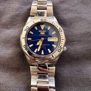 Vintage Seiko Sports 5 Blue Face w/ Gold Accents Silver Band Transparent back